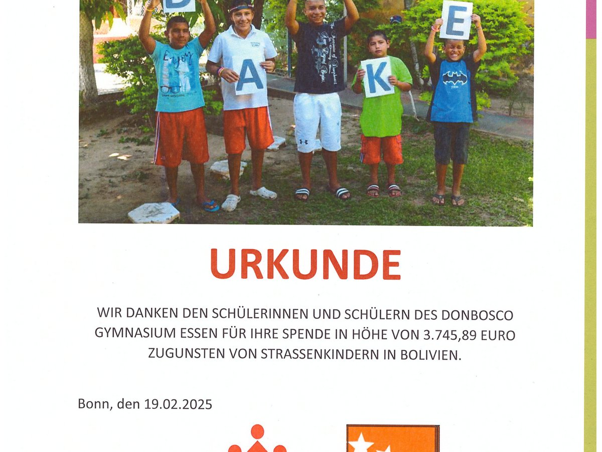 Fünf Kinder halten Buchstaben, die 'DANKE' bilden. Eine Urkunde dankt Don Bosco Gymnasium Essen für eine Spende.